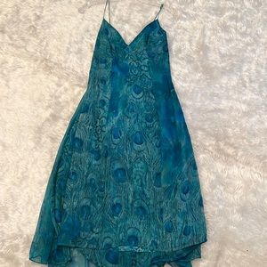 Aqua blue, spaghetti, string dress, silk fabric with peacock design. Size 8.